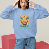 Women's light blue sweatshirt with “THIS CHICK IS RETIRED” palm graphic, long sleeves
