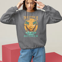 Women's charcoal sweatshirt with “THIS CHICK IS RETIRED” palm graphic, relaxed pullover