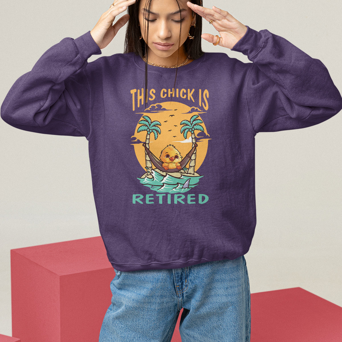 Women's purple sweatshirt with “THIS CHICK IS RETIRED” palm and boat graphic, crewneck