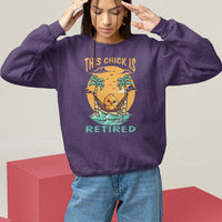 Women's purple sweatshirt with “THIS CHICK IS RETIRED” palm and boat graphic, crewneck