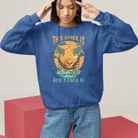 Women's navy crewneck sweatshirt with “THIS CHICK IS RETIRED” palm and surfboard graphic