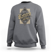 Charcoal retirement sweatshirt with diamond “Retired” graphic on the chest