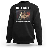 Black crewneck sweatshirt with 'Retired' cat newspaper graphic, 'Not My Problem Anymore'.