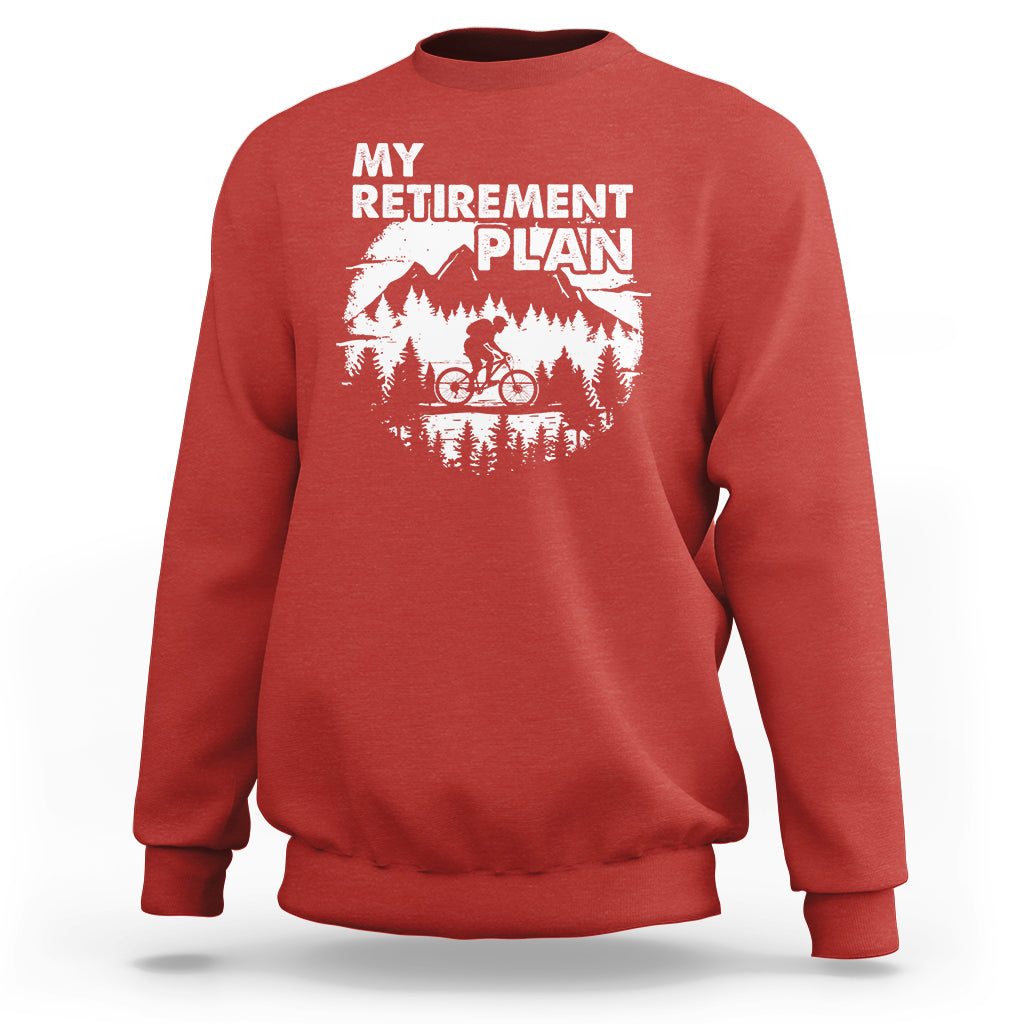 Red crewneck sweatshirt with 'MY RETIREMENT PLAN' bicycle graphic, back view