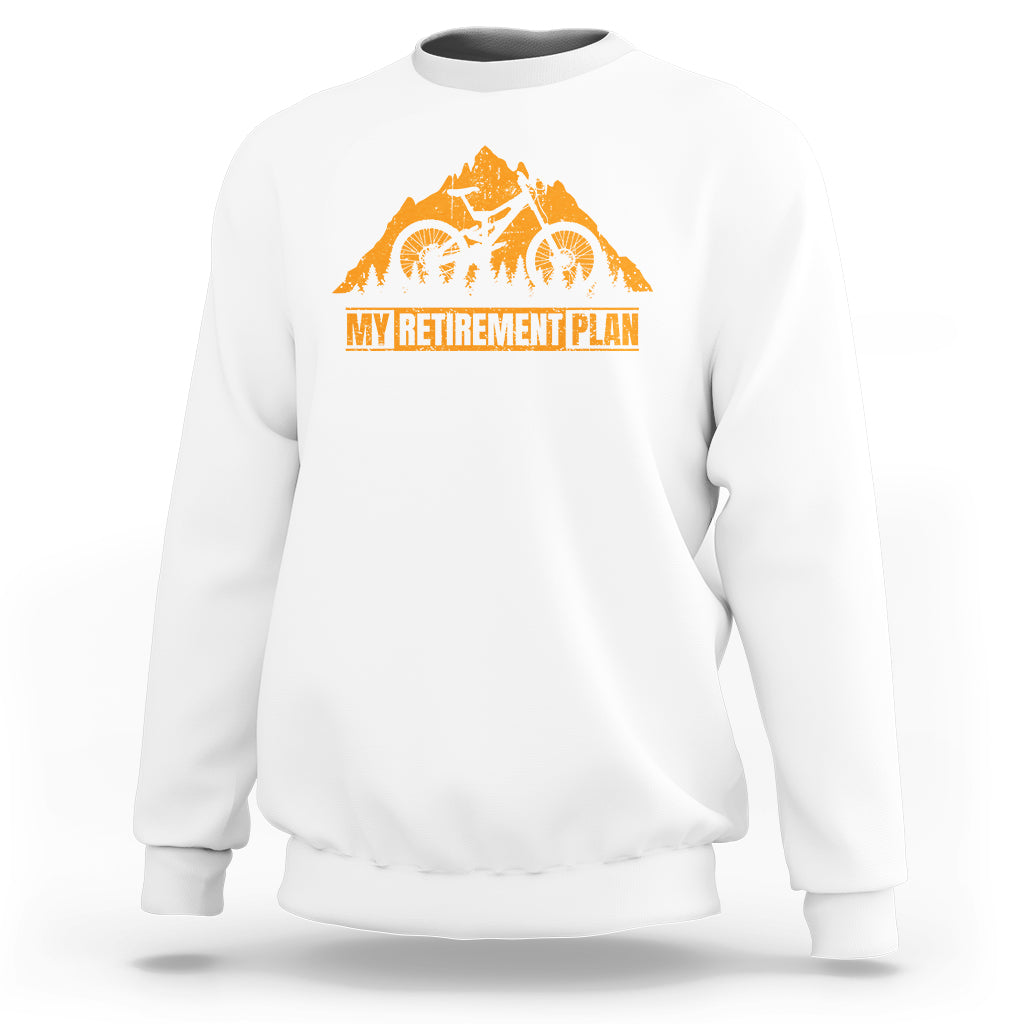White crewneck sweatshirt with orange bicycle retirement plan graphic