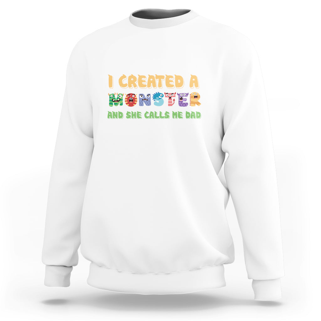 White sweatshirt with “I created a monster” dad graphic on front
