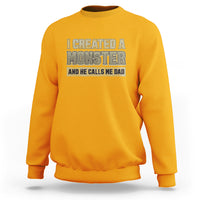 Men's gold sweatshirt with 'I created a monster' graphic on front