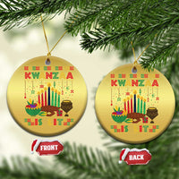 Two gold round Kwanzaa ornaments on a tree, shown with “FRONT” and “BACK” tags