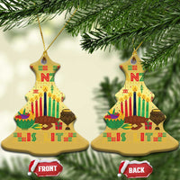 Two gold tree-shaped Kwanzaa ornaments with “Kwanzaa,” candles, and “FRONT/BACK” tags