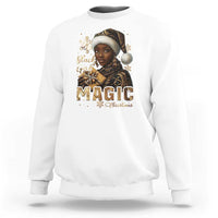 White crewneck sweatshirt with front holiday graphic and gold "MAGIC" lettering