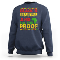 Navy crewneck sweatshirt with colorful 'Black Is Beautiful' graphic on chest