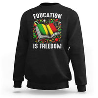 Black sweatshirt with “EDUCATION IS FREEDOM” book graphic