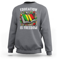 Charcoal sweatshirt with “EDUCATION IS FREEDOM” book graphic