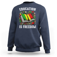 Navy sweatshirt with “EDUCATION IS FREEDOM” book graphic