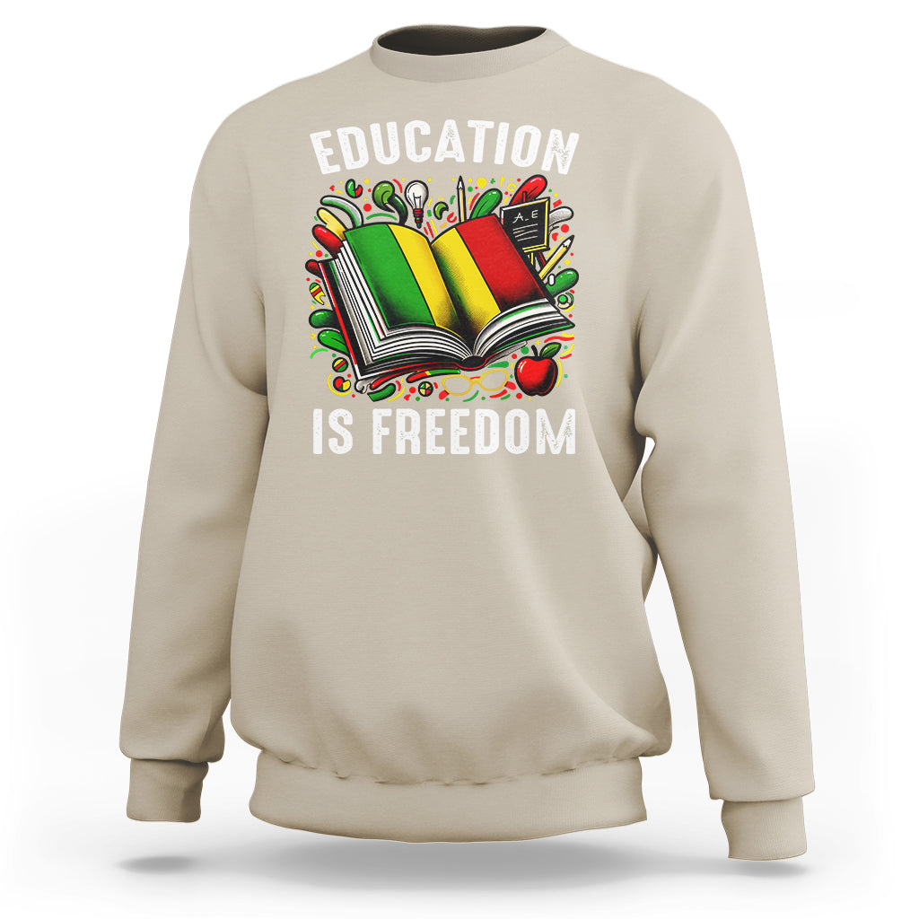 Sand sweatshirt with “EDUCATION IS FREEDOM” book graphic