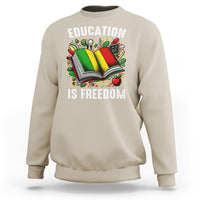 Sand sweatshirt with “EDUCATION IS FREEDOM” book graphic