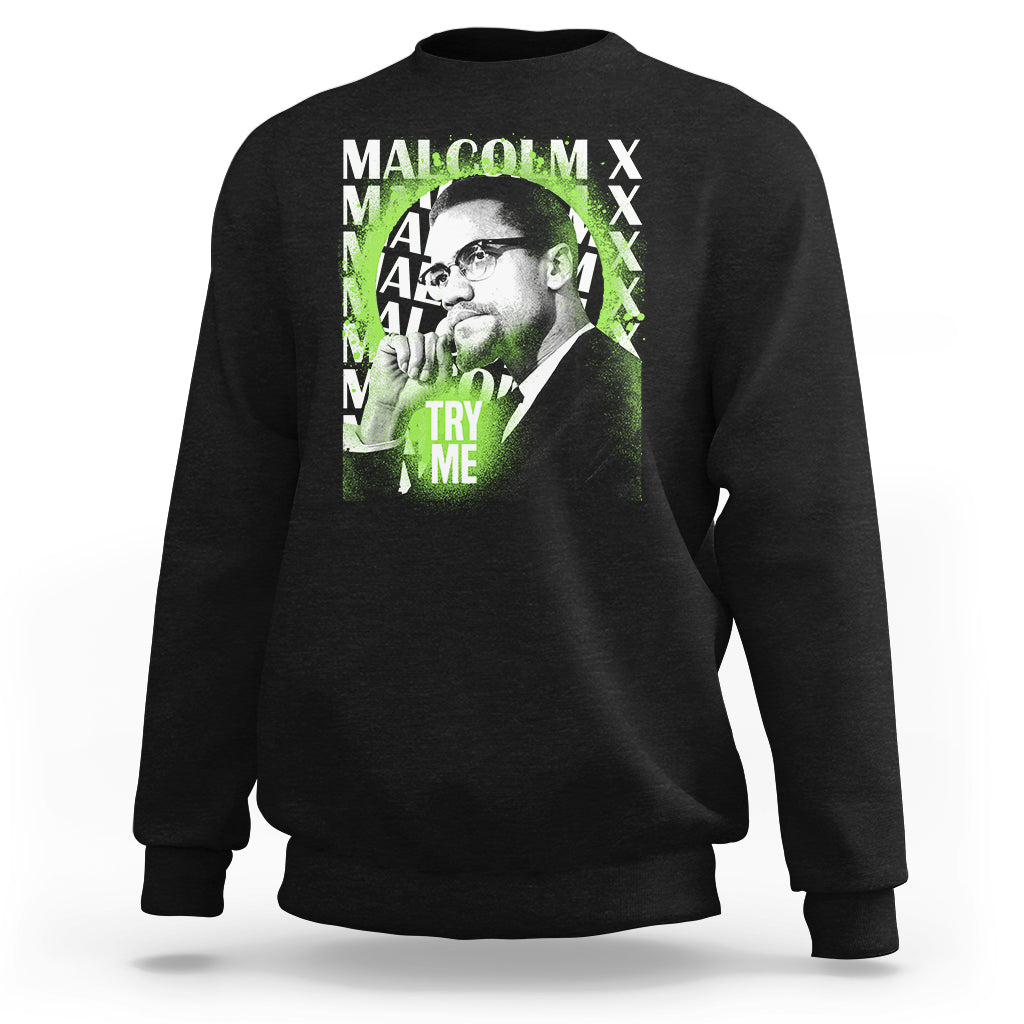 Black crewneck sweatshirt with Malcolm X portrait graphic and “Try Me” text