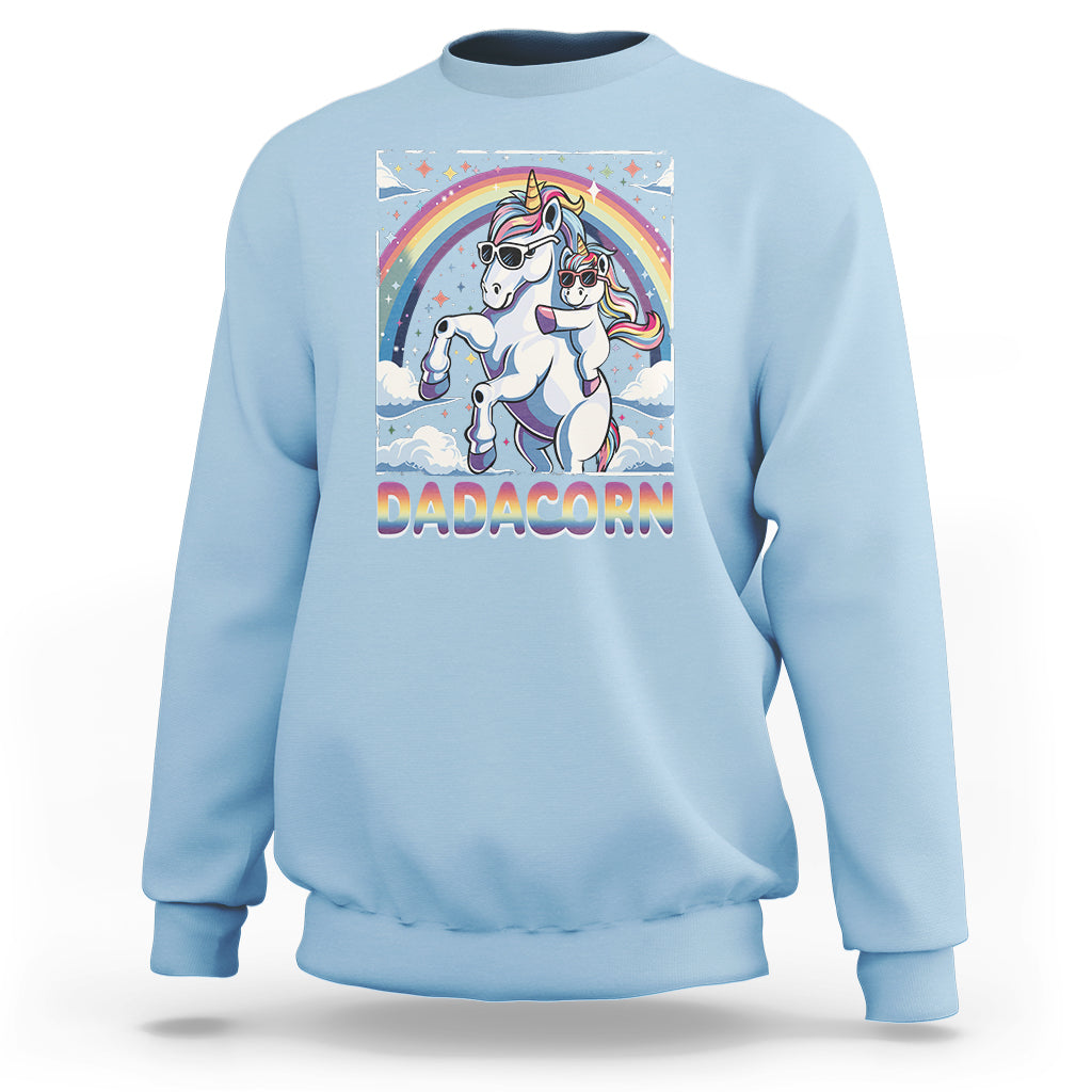 Light blue sweatshirt with unicorn graphic and rainbow arch on the front