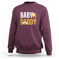 Maroon crewneck sweatshirt with 'BABY DADDY' text and baby icon graphic