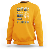 Gold crewneck sweatshirt with colorful "Step Dad" text and hand graphic print