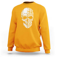 Gold crewneck sweatshirt with white skull graphic on back