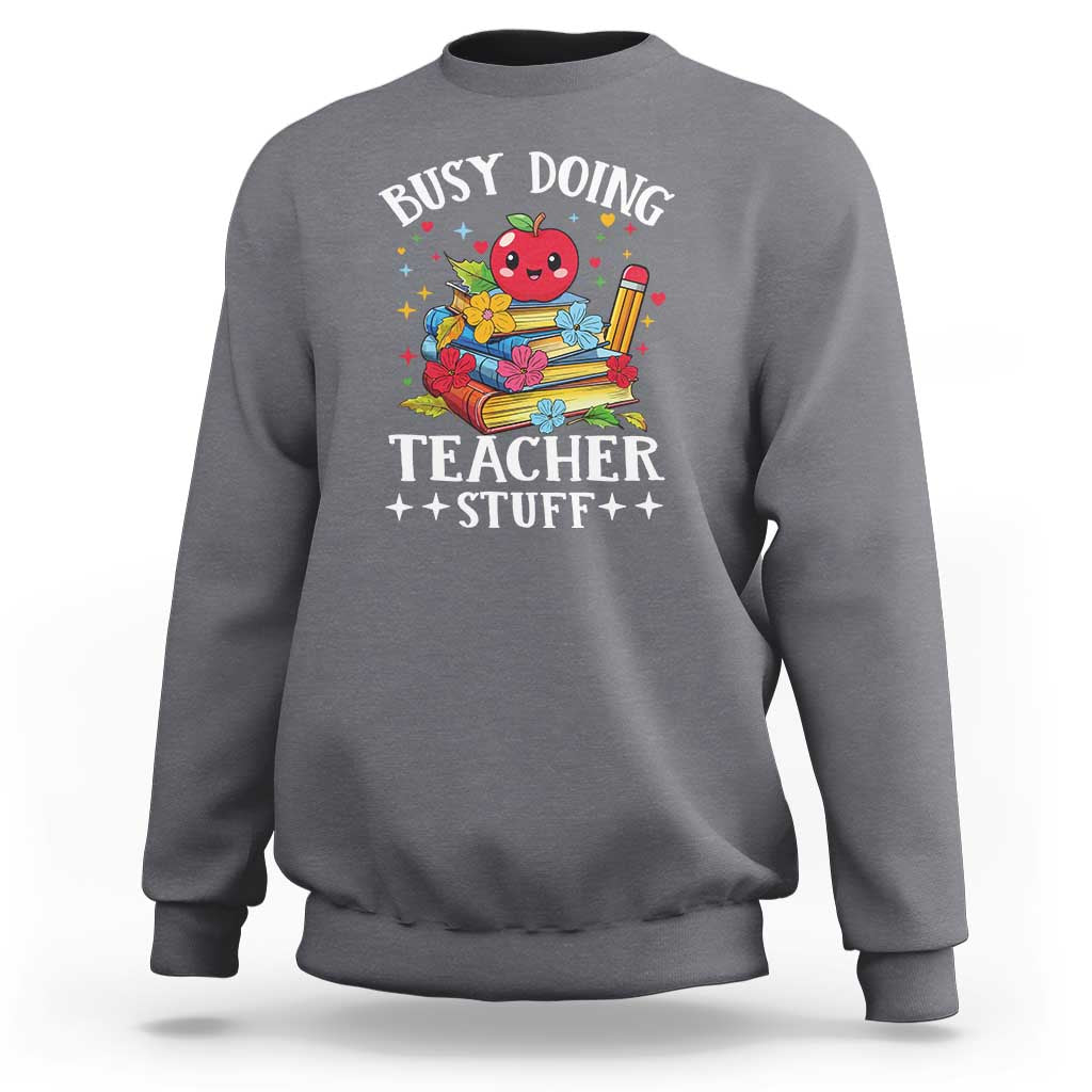 Charcoal gray crewneck sweatshirt with colorful “Busy Doing Teacher Stuff” graphic on chest.