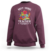 Maroon crewneck sweatshirt with colorful “Busy Doing Teacher Stuff” graphic on chest.