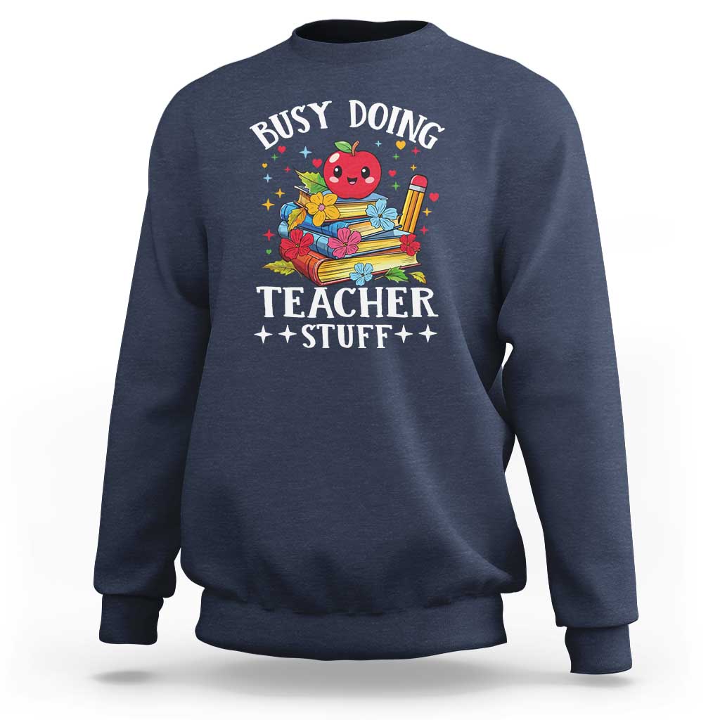 Navy crewneck sweatshirt with colorful “Busy Doing Teacher Stuff” graphic on chest.