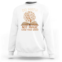 White sweatshirt with math and book graphic reading “Do math” and “Not magic”