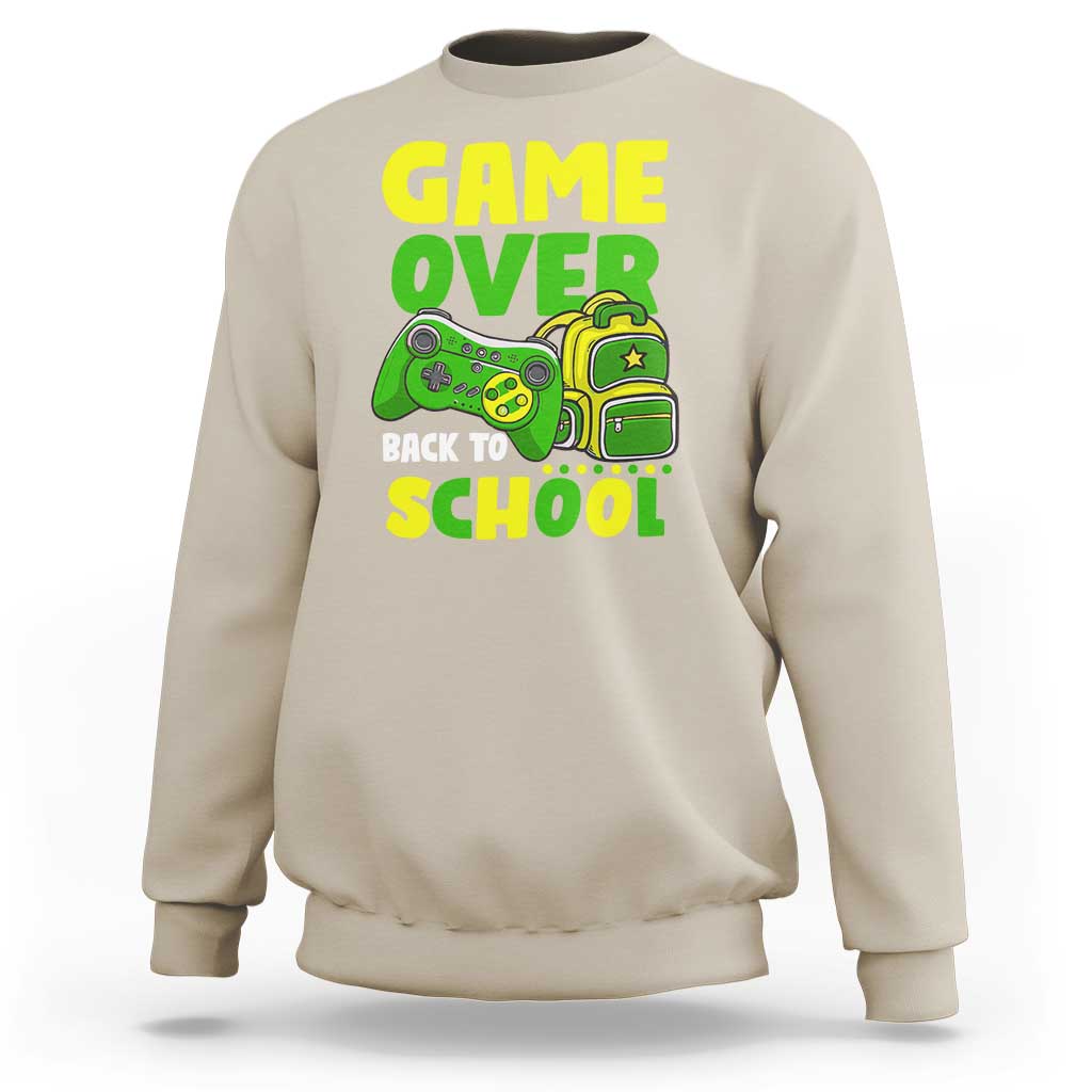 Cream crewneck sweatshirt with “GAME OVER” and game-themed “BACK TO SCHOOL” graphic