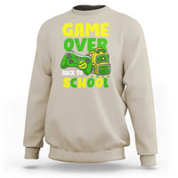 Cream crewneck sweatshirt with “GAME OVER” and game-themed “BACK TO SCHOOL” graphic