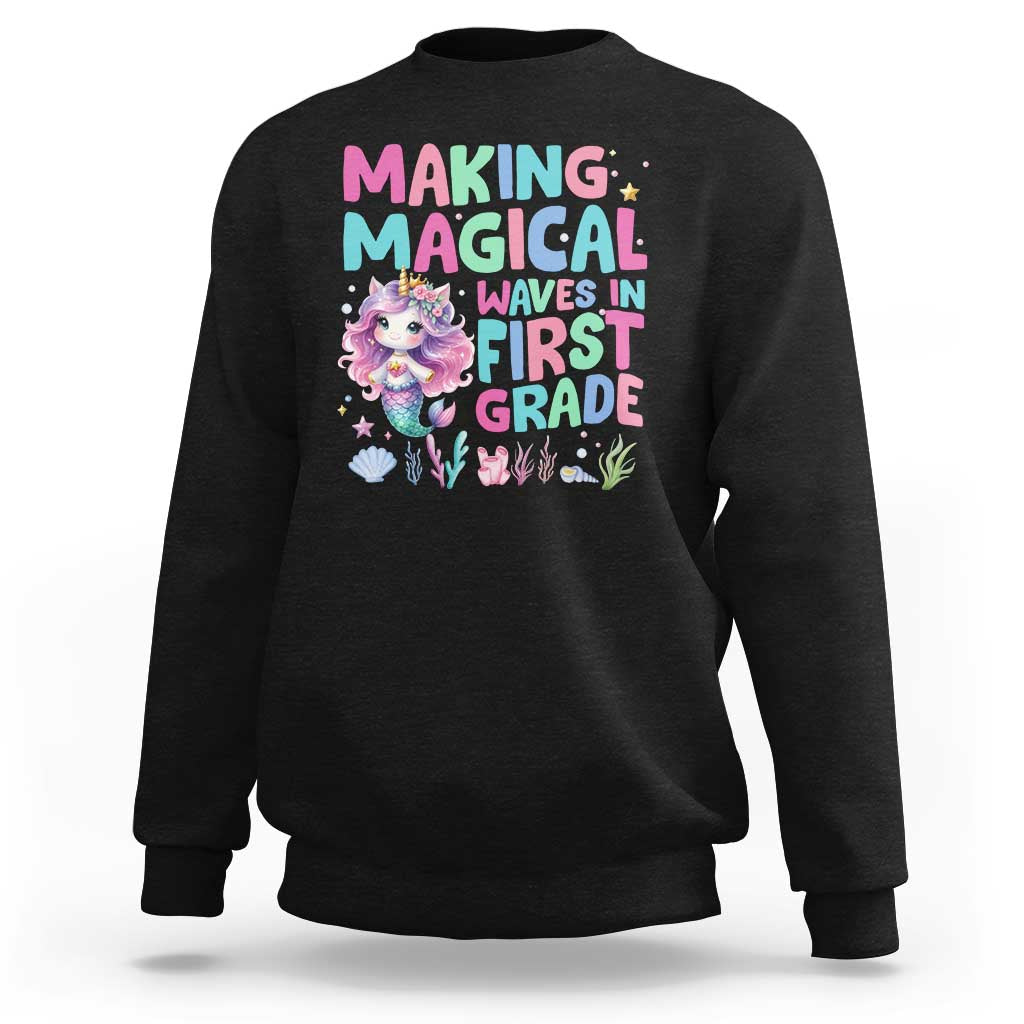Black sweatshirt with mermaid graphic and “MAGICAL WAVES IN FIRST GRADE” text