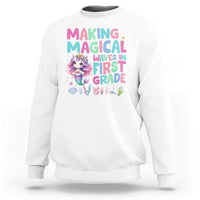 White sweatshirt with mermaid graphic and “MAGICAL WAVES IN FIRST GRADE” text