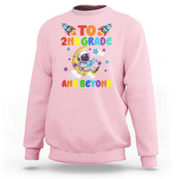 Light pink sweatshirt with astronaut graphic and text “To 2nd grade and beyond”