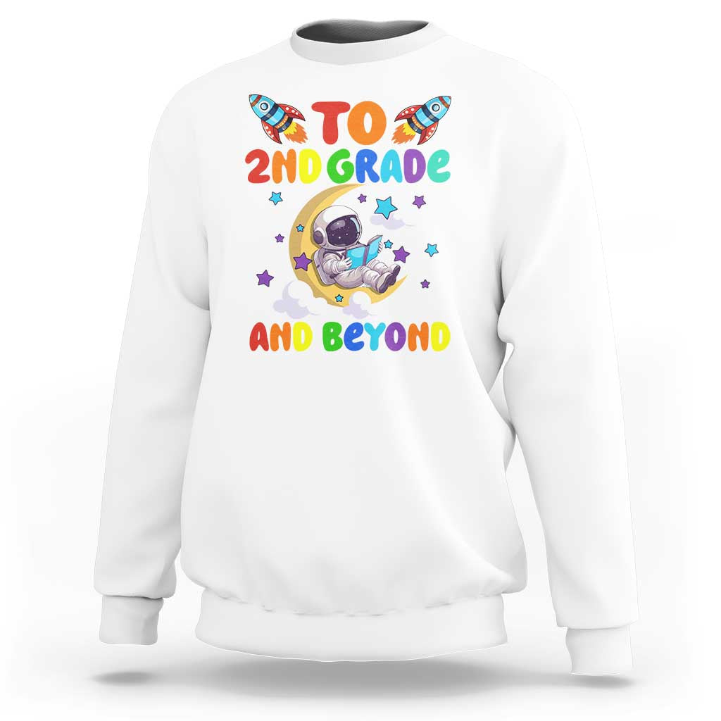White sweatshirt with astronaut graphic and text “To 2nd grade and beyond”
