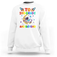 White sweatshirt with astronaut graphic and text “To 2nd grade and beyond”