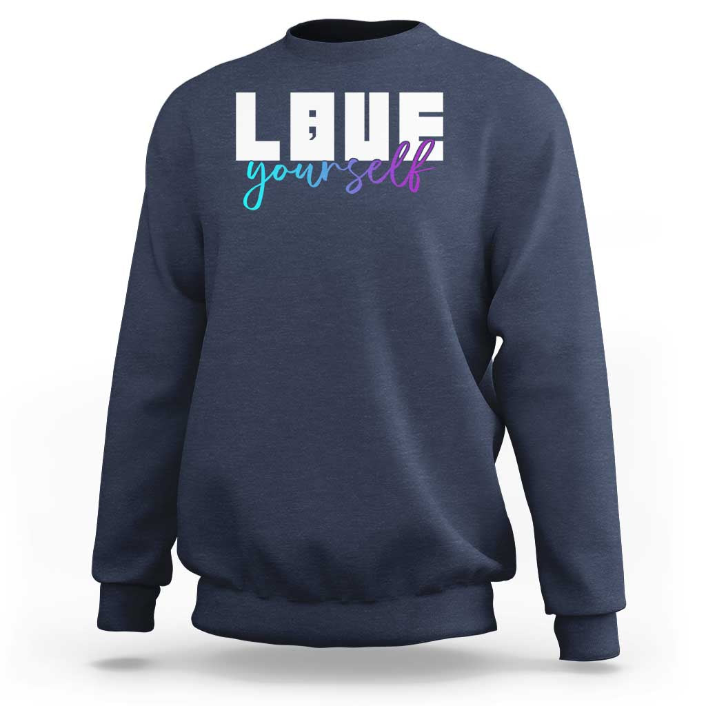 Navy sweatshirt with “Love yourself” graphic and semicolon on front