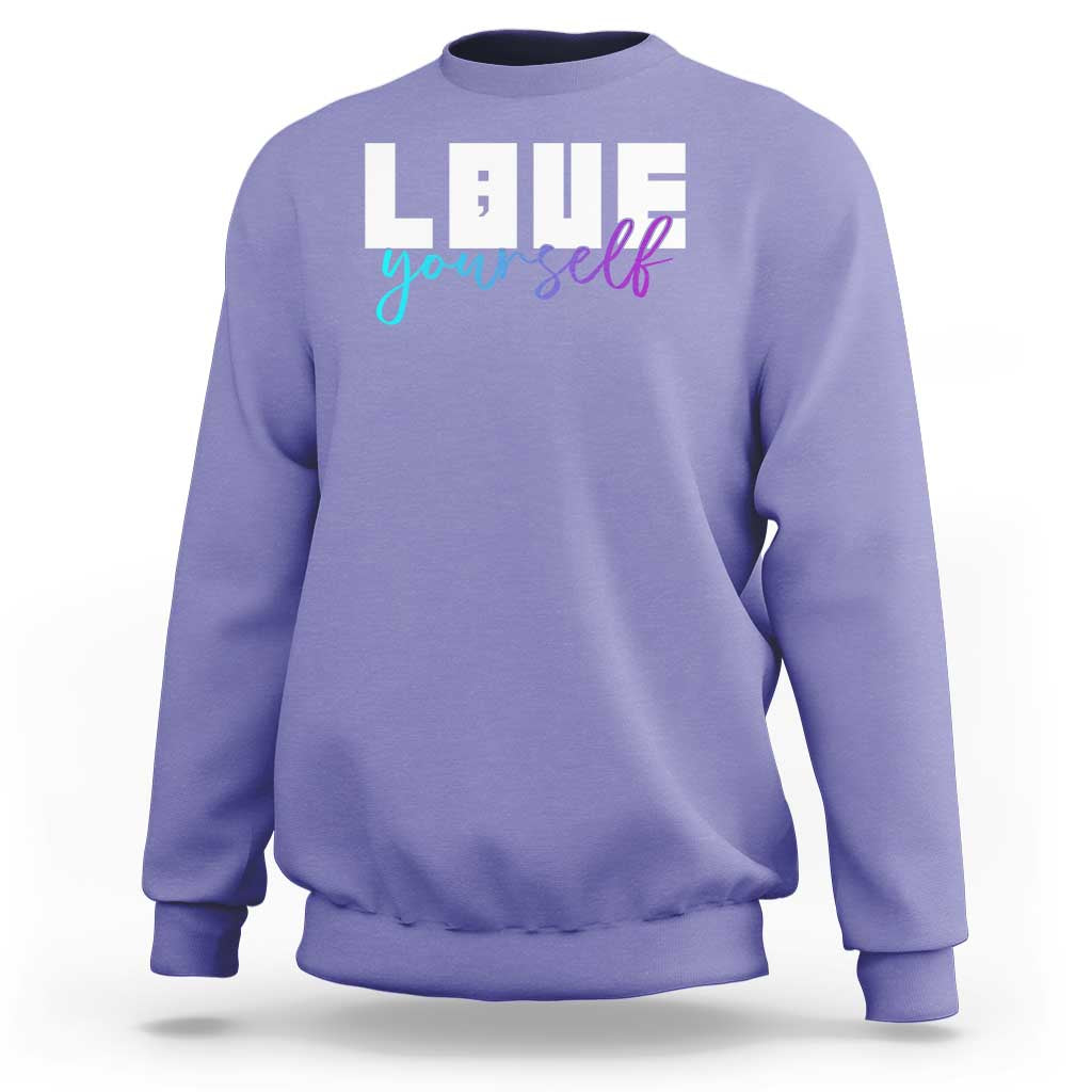 Lavender sweatshirt with “Love yourself” graphic and semicolon on front