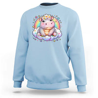 Light blue baby hippo sweatshirt with pastel rainbow and flower graphic on front