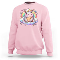 Light pink baby hippo sweatshirt with pastel rainbow and flower graphic on front