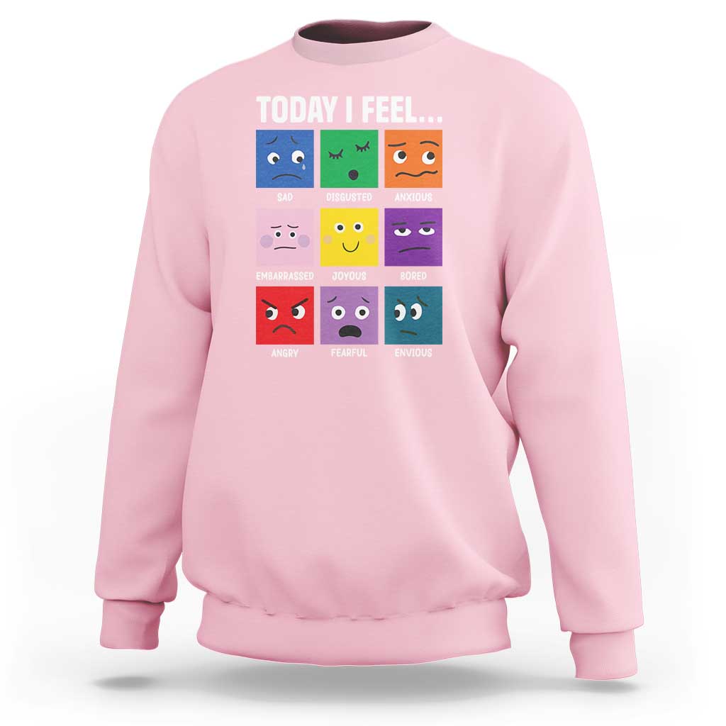 Light pink sweatshirt with colorful emotion face grid graphic and “Today I Feel...” text