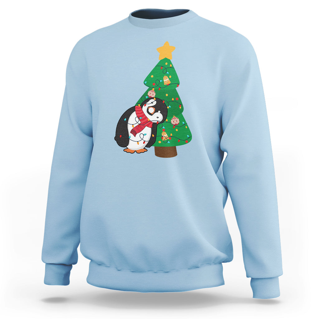 Light blue sweatshirt with penguin holding Christmas tree light graphic on chest