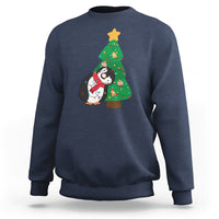 Navy sweatshirt with penguin holding Christmas tree light graphic on chest