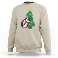 Sand sweatshirt with penguin holding Christmas tree light graphic on chest