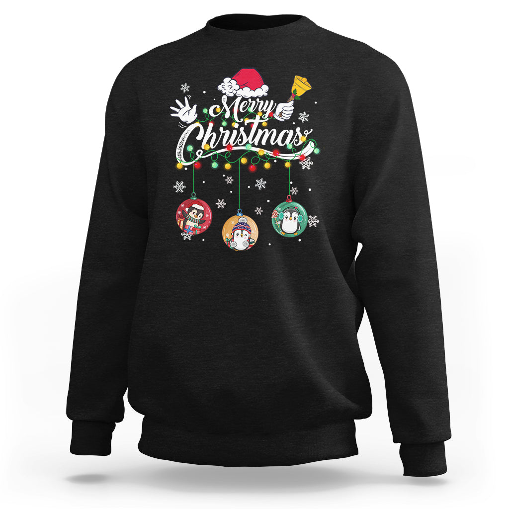 Black crewneck sweatshirt with “Merry Christmas” penguin ornaments graphic on front