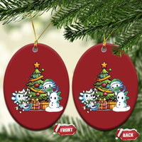 Pair of red oval axolotl Christmas ornaments with tree scene, gold hanging loops