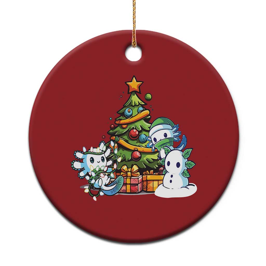 Red round axolotl Christmas ornament with tree scene, gold hanging loop
