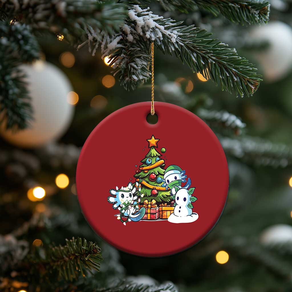 Red round axolotl Christmas ornament with tree scene, gold hanging loop on pine