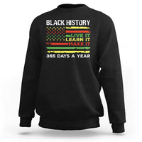 Black crewneck sweatshirt with 'BLACK HISTORY' text and 'LIVE IT LEARN IT MAKE IT' print.