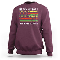 Maroon crewneck sweatshirt with 'BLACK HISTORY' text and 'LIVE IT LEARN IT MAKE IT' print.
